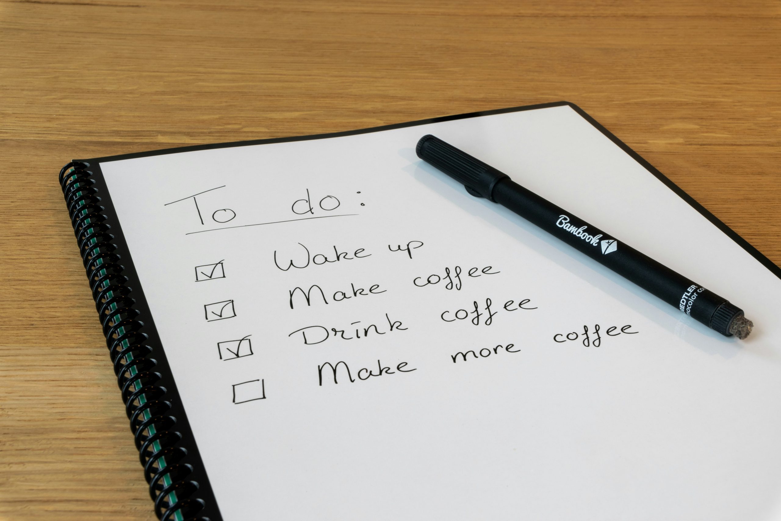 notepad and pen for planning daily tasks with eat the frog method