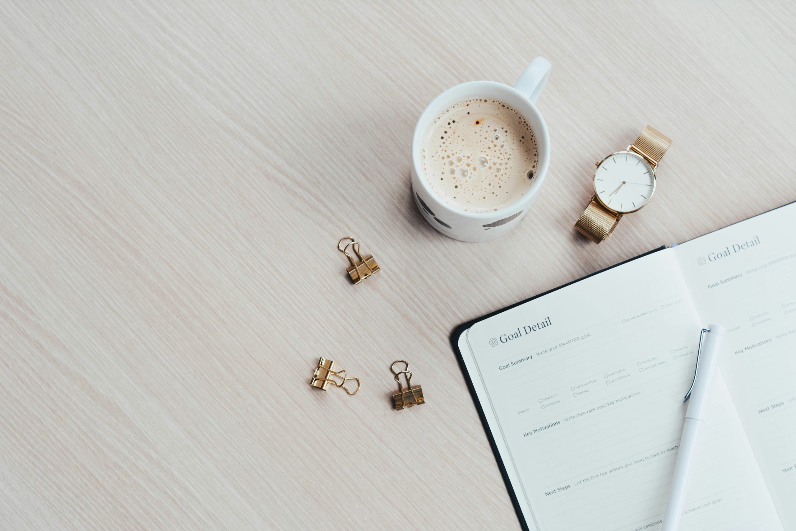 paper and mug on desk for building daily habits with habit stacking
