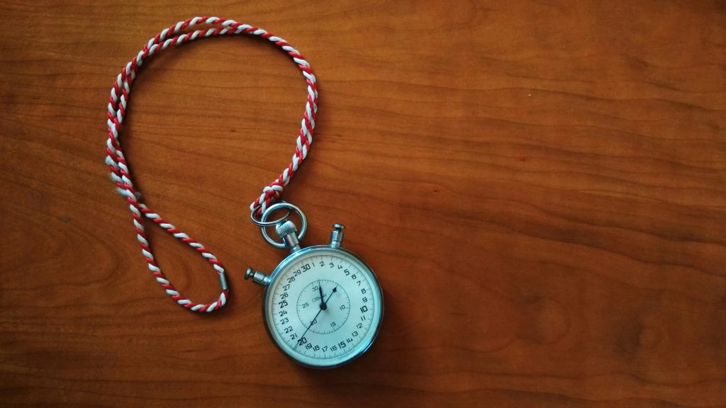 time tracking for remote workers antique stopwatch on wooden desk