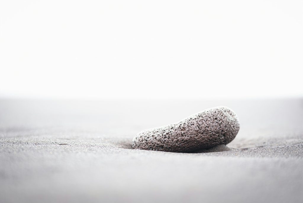 single tasking vs multitasking illustrated by single stone on white background