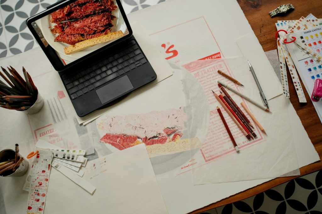 work from home with kids laptop surrounded by art supplies and colored pencils