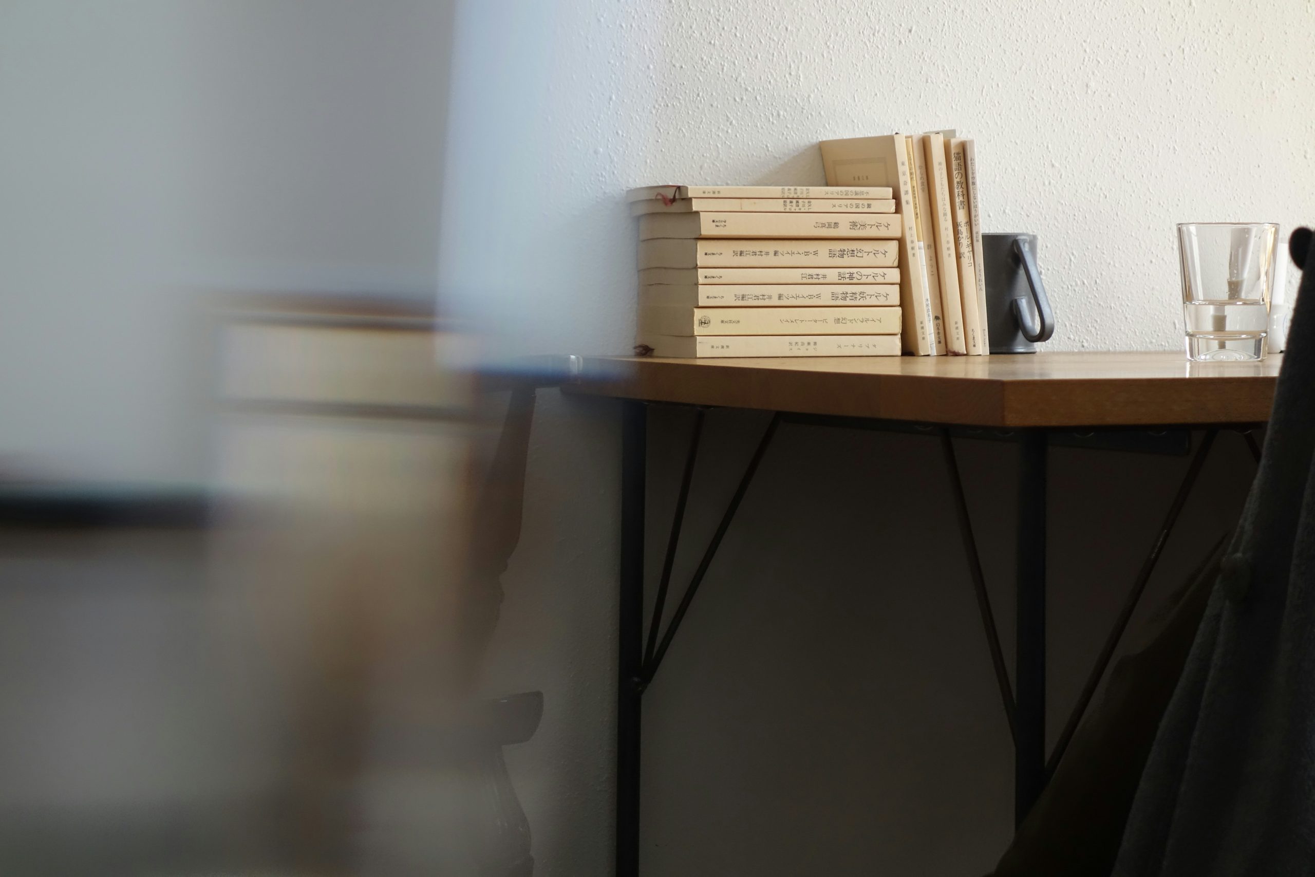 stacked books and glass on wooden table for reading