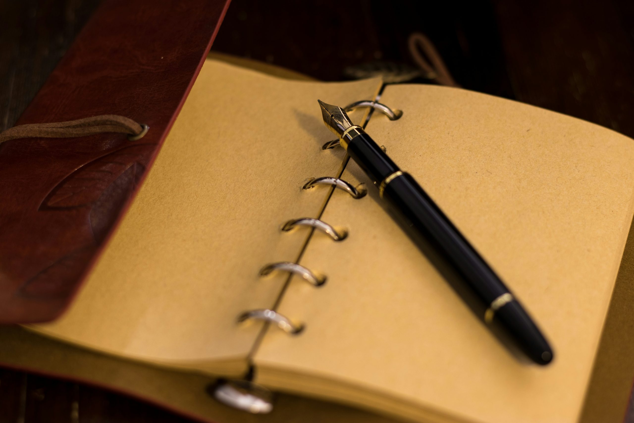 handwritten notebook and pen used for a daily journaling habit